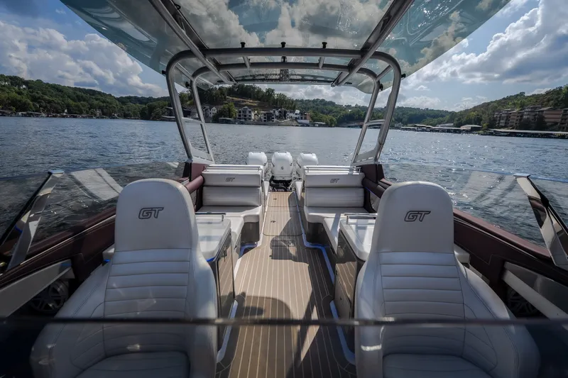 Slide: The Image of 2019 Donzi 41 GT boat interior with luxurious seating on a scenic lake. - 38