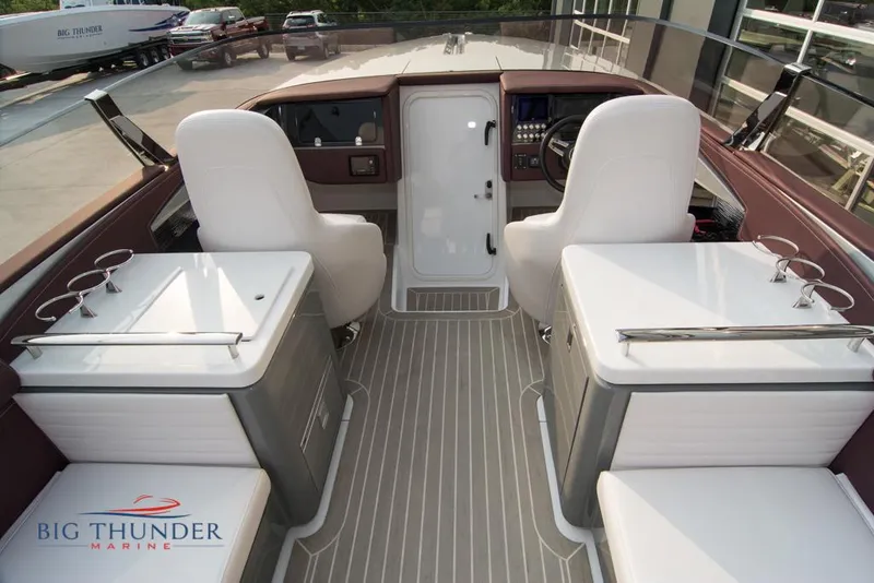 Slide: The Image of 2019 Donzi 41 GT boat interior with white seats and Big Thunder Marine logo. - 41