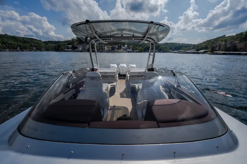 Slide: The Image of 2019 Donzi 41 GT boat on a scenic lake under a partly cloudy sky. - 37