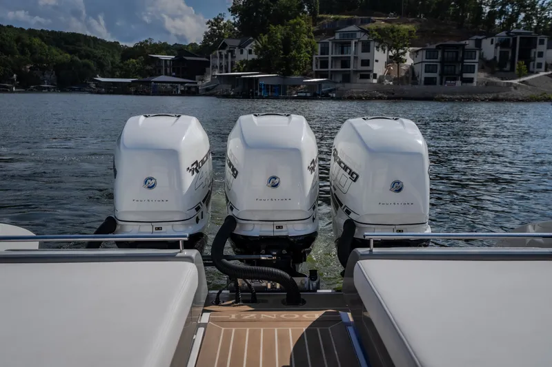Slide: The Image of 2019 Donzi 41 GT boat with triple Mercury outboard engines on a scenic lake. - 18