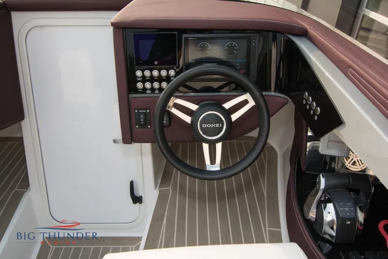 Slide: The Image of 2019 Donzi 41 GT boat steering wheel and dashboard with Big Thunder Marine logo. - 49