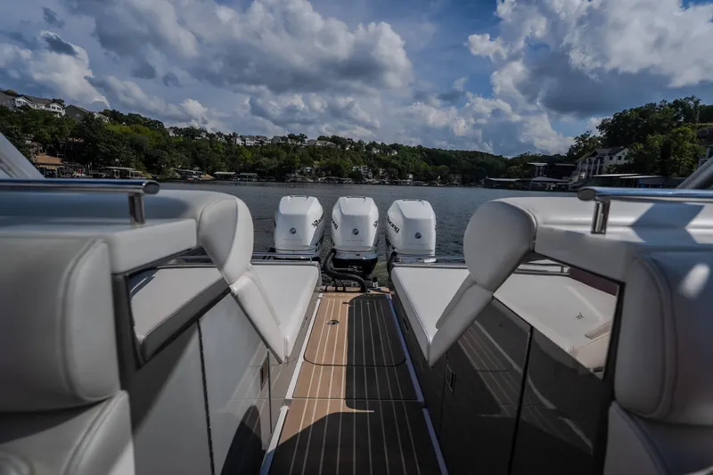 Slide: The Image of 2019 Donzi 41 GT boat with four engines, docked on a scenic lake. - 16
