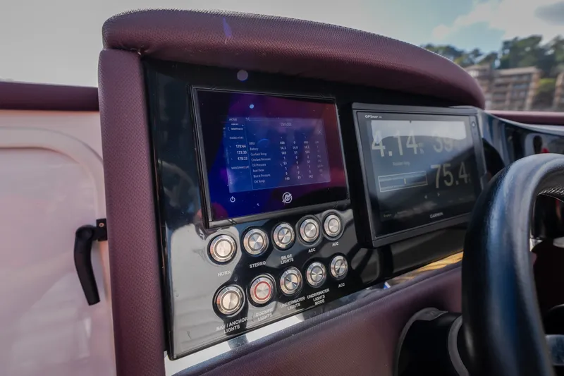 Slide: The Image of Dashboard of a 2019 Donzi 41 GT boat with digital displays and control buttons. - 49