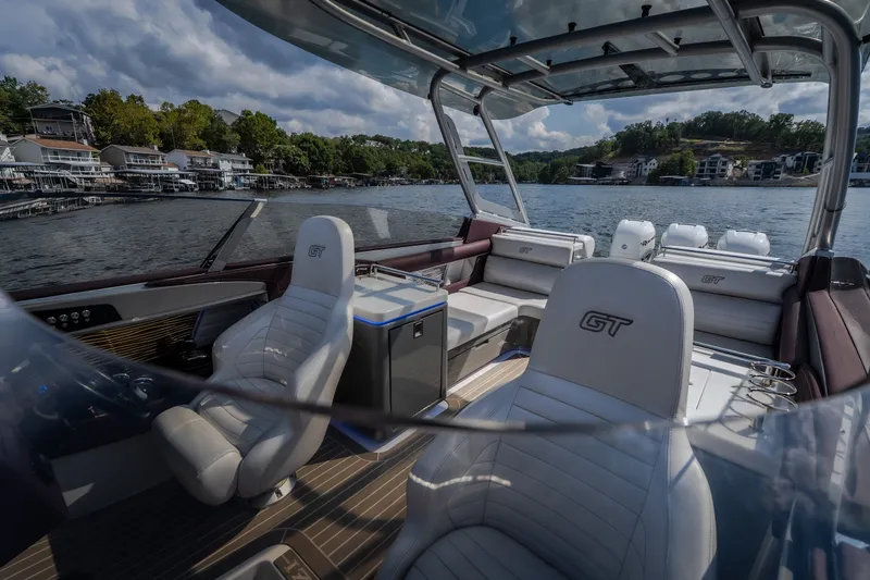 Slide: The Image of 2019 Donzi 41 GT boat interior with luxurious seating on a scenic lake. - 39