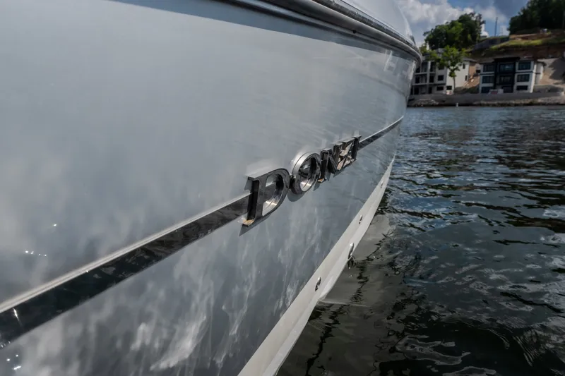 Slide: The Image of 2019 Donzi 41 GT boat on water, close-up of logo and hull. - 15