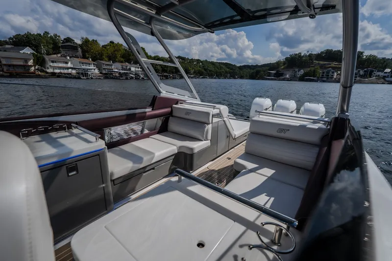 Slide: The Image of 2019 Donzi 41 GT boat interior with luxurious seating on a scenic lake. - 40