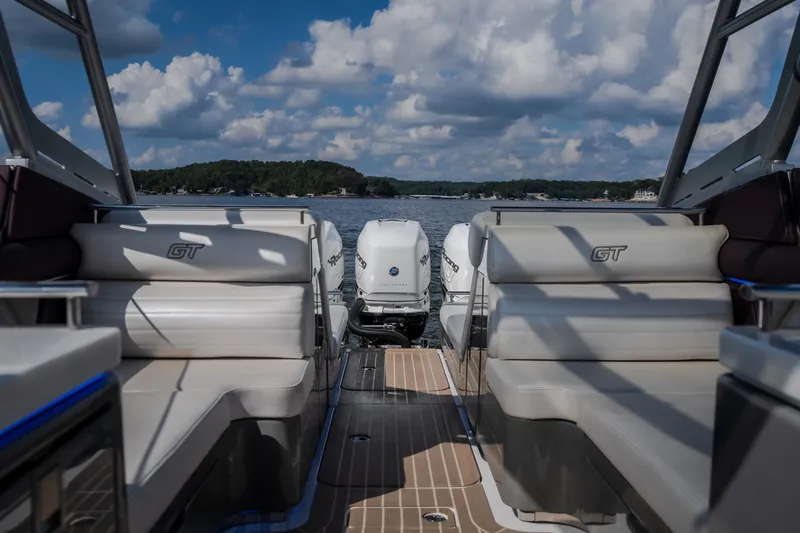 Slide: The Image of 2019 Donzi 41 GT boat interior with twin engines, lake view, and cloudy sky. - 26