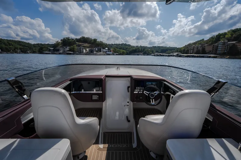 Slide: The Image of Cockpit view of 2019 Donzi 41 GT boat on a scenic lake. - 41