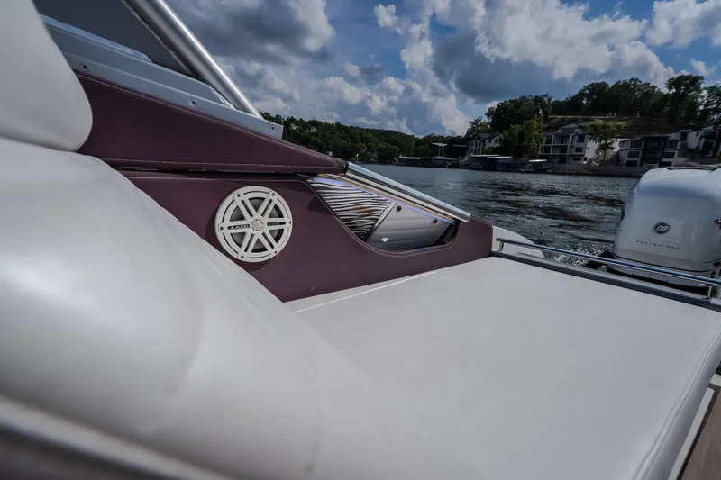 Slide: The Image of 2019 Donzi 41 GT boat interior with speaker, lake view, and cloudy sky. - 20