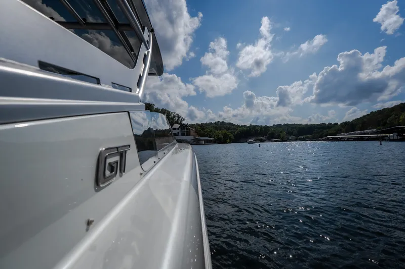 Slide: The Image of 2019 Donzi 41 GT boat on a sunny lake with blue sky and clouds. - 12