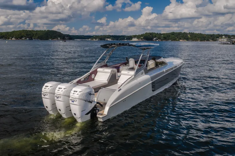 Slide: The Image of 2019 Donzi 41 GT boat with triple outboard engines on a scenic lake. - 8