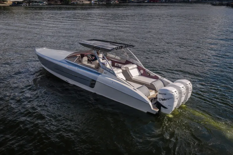 Slide: The Image of 2019 Donzi 41 GT boat with triple outboard engines on water. - 7