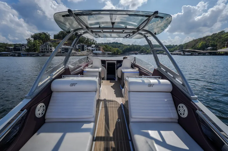 Slide: The Image of 2019 Donzi 41 GT luxury boat interior with sleek seating on a sunny lake. - 23