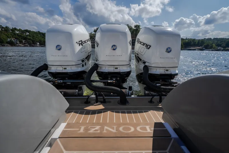 Slide: The Image of 2019 Donzi 41 GT boat with triple Mercury Racing outboard engines on a sunny lake. - 21