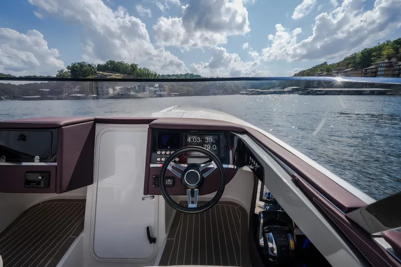 Slide: The Image of Cockpit view of 2019 Donzi 41 GT boat on a sunny day, overlooking calm waters. - 45
