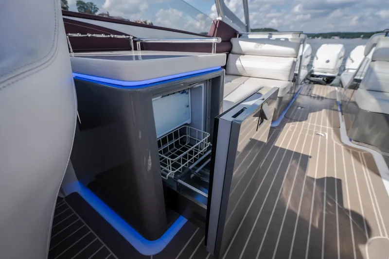 Slide: The Image of 2019 Donzi 41 GT boat interior with open mini fridge and luxurious seating. - 29
