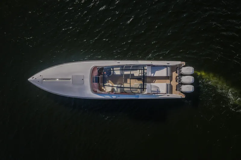 Slide: The Image of Aerial view of 2019 Donzi 41 GT boat cruising on dark water. - 1