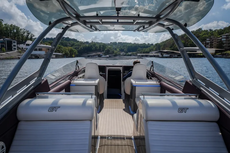 Slide: The Image of 2019 Donzi 41 GT boat interior with luxurious seating on a scenic lake. - 22