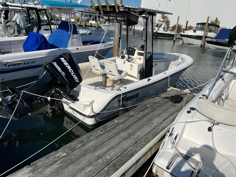 Slide: The Image of 2008 Mako 204 CC boat docked with Mercury outboard motor. - 0