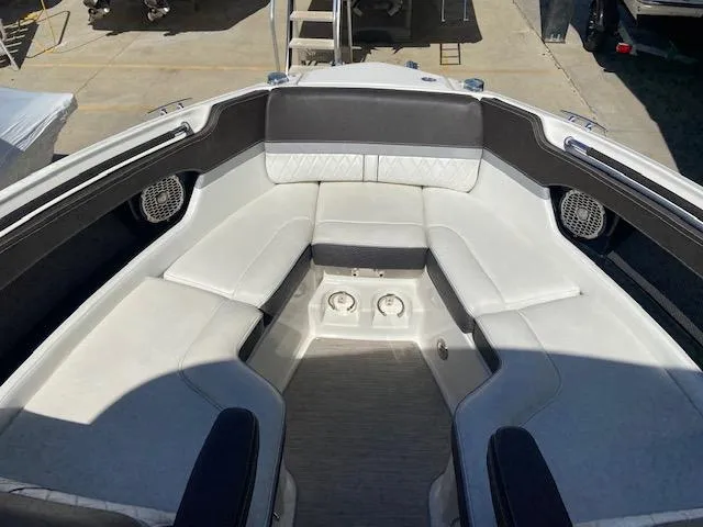Slide: The Image of 2017 Sea Ray 250 SLX boat interior with cushioned seating and cup holders. - 10