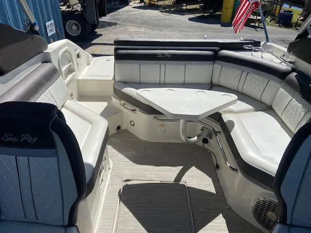 Slide: The Image of 2017 Sea Ray 250 SLX boat interior with white and black seating and table. - 11