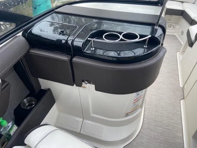 Slide: The Image of 2017 Sea Ray 250 SLX boat interior with cup holders and seating area. - 17