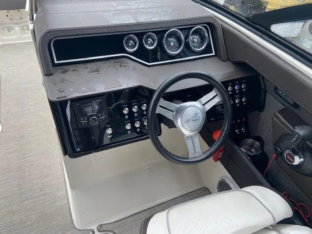 Slide: The Image of 2017 Sea Ray 250 SLX boat dashboard with steering wheel and control panel. - 18