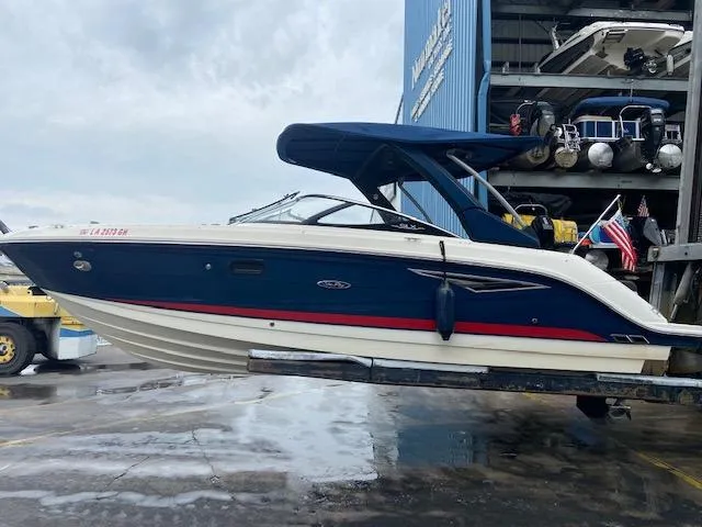 Slide: The Image of 2017 Sea Ray 250 SLX boat in dry dock with blue and white hull. - 2