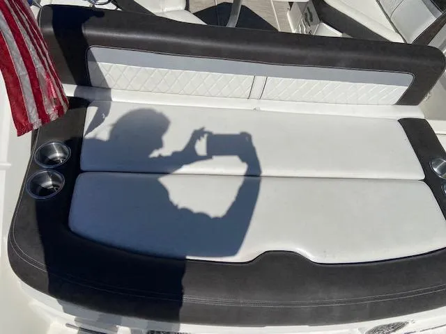 Slide: The Image of 2017 Sea Ray 250 SLX boat with white and black seating, cup holders, and shadow of a person. - 20