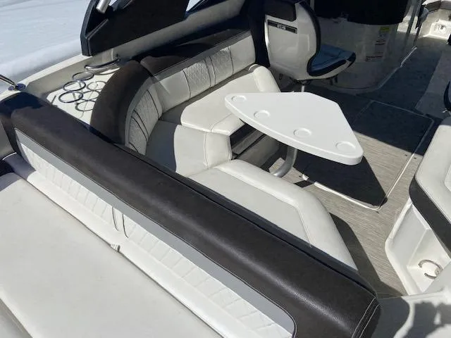 Slide: The Image of 2017 Sea Ray 250 SLX boat interior with white leather seating and a small table. - 21