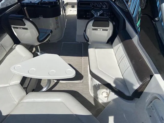 Slide: The Image of Interior of a 2017 Sea Ray 250 SLX boat with seating and table. - 22