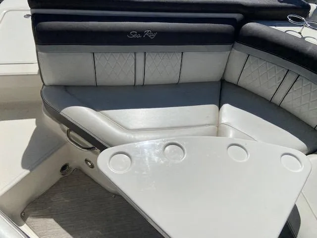 Slide: The Image of 2017 Sea Ray 250 SLX boat interior with cushioned seating and cup holders. - 23