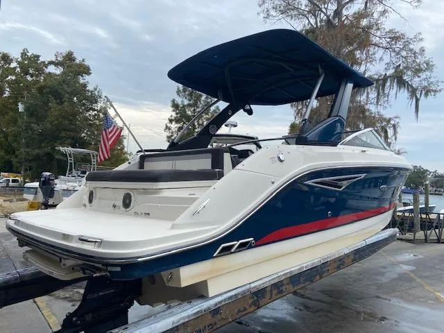 Slide: The Image of 2017 Sea Ray 250 SLX boat on a trailer with a blue canopy. - 7