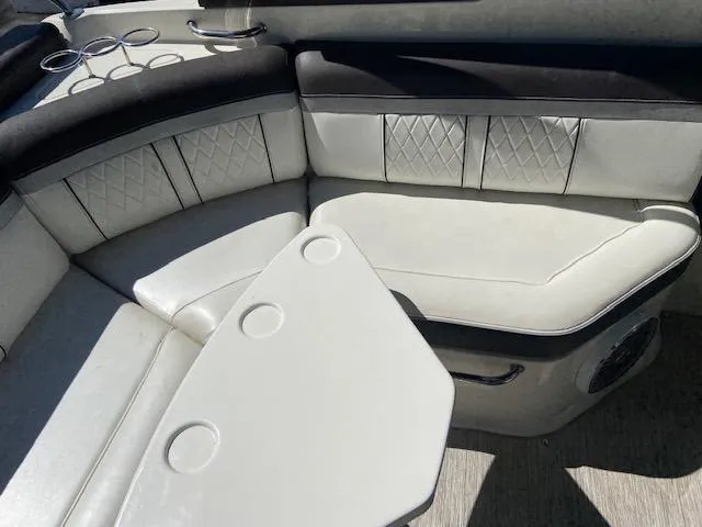 Slide: The Image of 2017 Sea Ray 250 SLX boat interior with white leather seating and cup holders. - 8