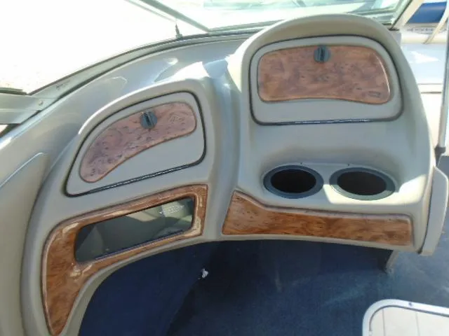 Slide: The Image of 1998 Tahoe Q5L I/O boat dashboard with wood trim and cup holders. - 10