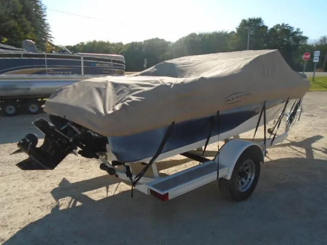 Slide: The Image of 1998 Tahoe Q5L I/O boat on trailer with protective cover. - 19