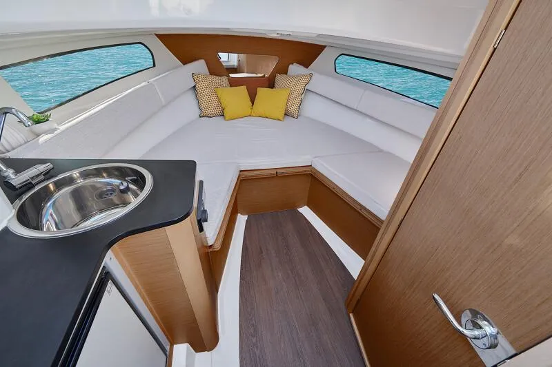 Slide: The Image of Interior of 2024 Jeanneau Leader 7.5 WA S3 with cozy seating and kitchenette. - 11
