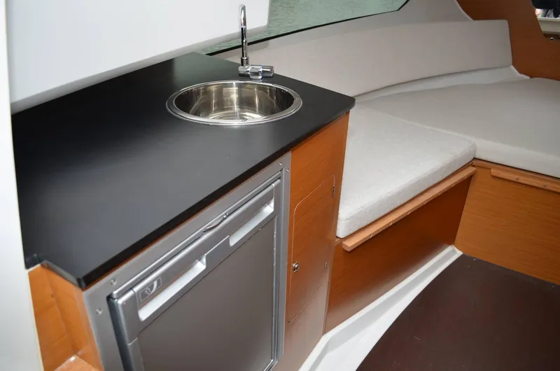 Slide: The Image of 2024 Jeanneau Leader 7.5 WA S3 interior with kitchenette and seating area. - 4