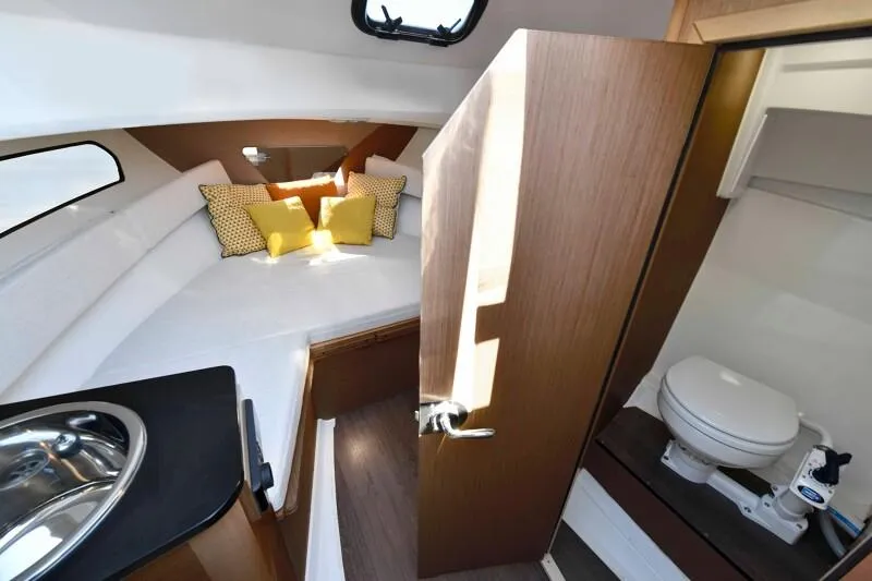 Slide: The Image of 2024 Jeanneau Leader 7.5 WA S3 cabin interior with bed and bathroom. - 7