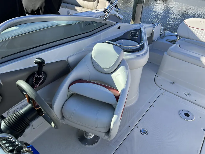 Slide: The Image of 2008 Crownline 240 EX boat interior with steering wheel and seating. - 6