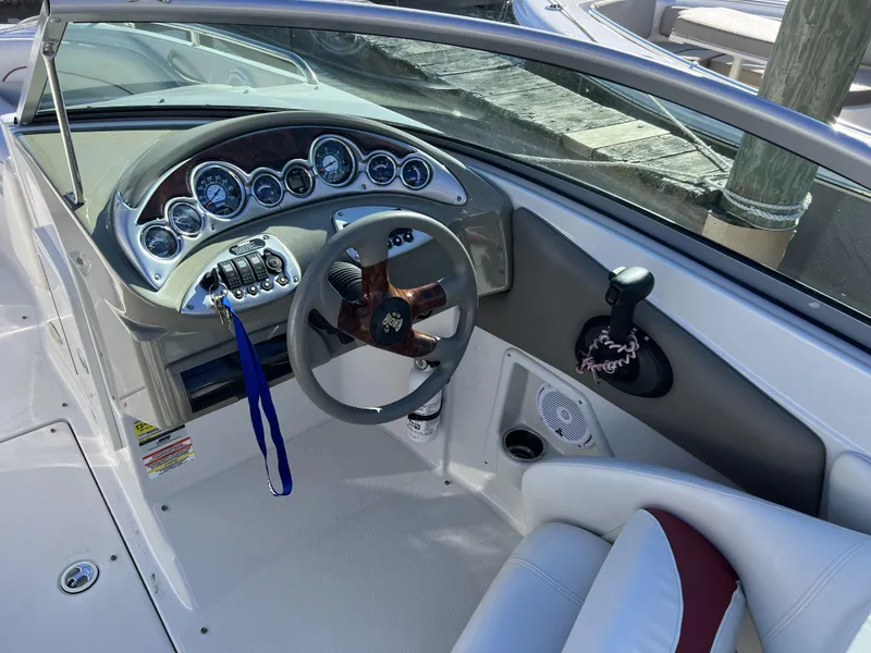 Slide: The Image of 2008 Crownline 240 EX boat dashboard with steering wheel and control panel. - 9