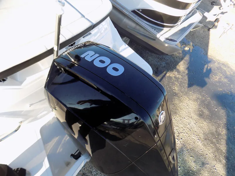 Slide: The Image of Outboard motor on a 2021 Sea Ray SPX 230 boat, parked on gravel. - 11
