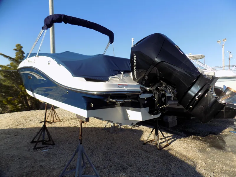 Slide: The Image of 2021 Sea Ray SPX 230 boat with outboard motor, covered and elevated on stands. - 3