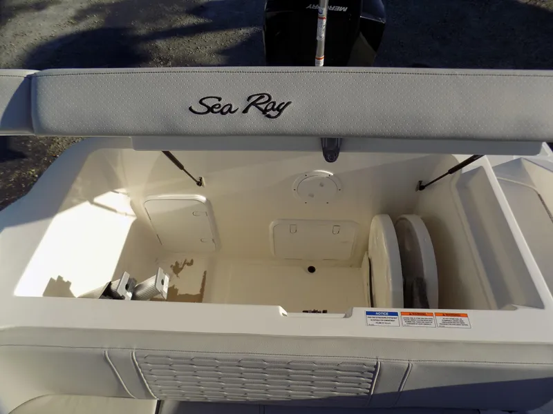 Slide: The Image of 2021 Sea Ray SPX 230 boat storage compartment with open hatch and visible seating. - 5