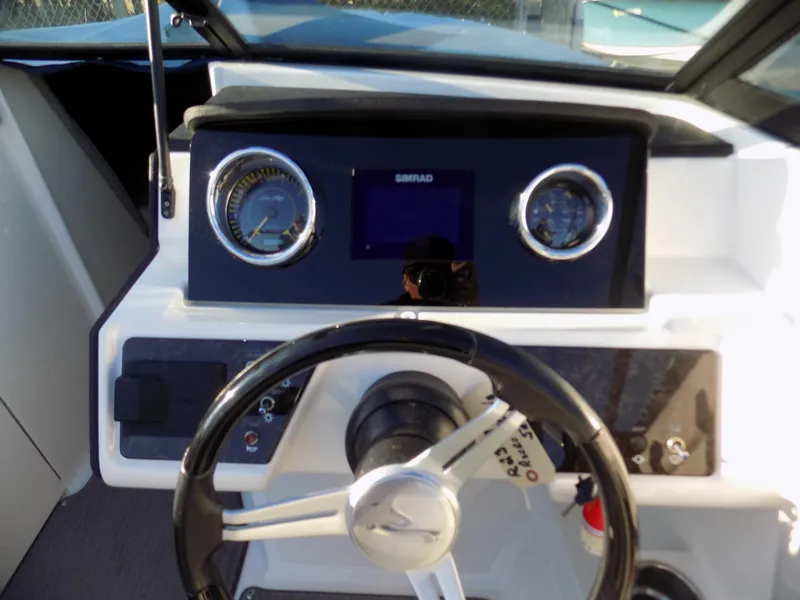 Slide: The Image of 2021 Sea Ray SPX 230 boat dashboard with steering wheel and gauges. - 6