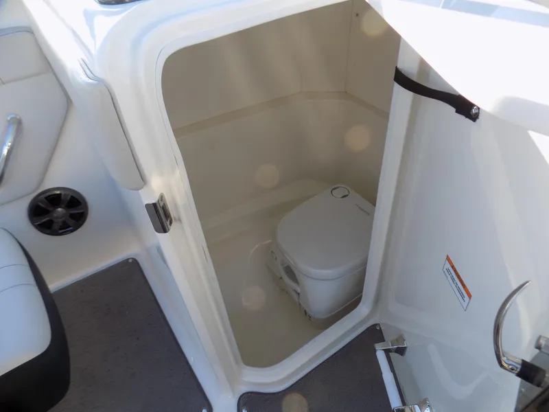 Slide: The Image of Interior of 2021 Sea Ray SPX 230 boat showing compact marine toilet. - 8