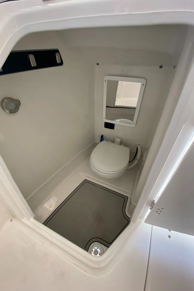 Slide: The Image of 2024 Sea Fox 268 Traveler boat interior bathroom with toilet and mirror. - 11
