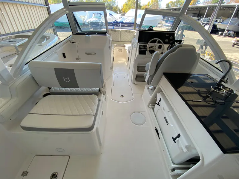 Slide: The Image of 2024 Sea Fox 268 Traveler interior, featuring helm, seating, and storage compartments. - 4