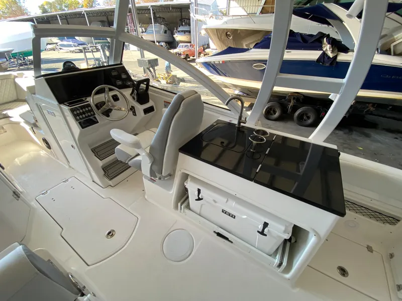 Slide: The Image of 2024 Sea Fox 268 Traveler boat interior with helm and seating area. - 6