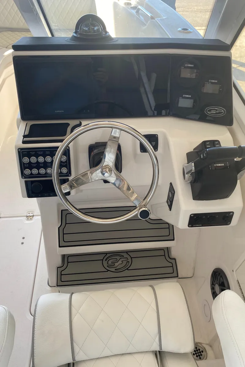 Slide: The Image of 2024 Sea Fox 268 Traveler boat helm with steering wheel and control panel. - 7